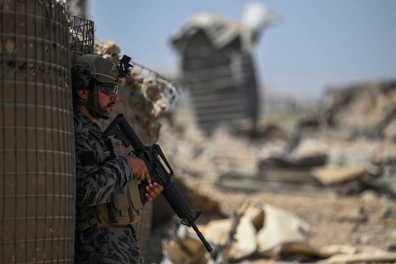 A member of the Taliban stands amid debris of the CIA base in Deh Sabz district, north-east of Kabul, on September 6.  AFP