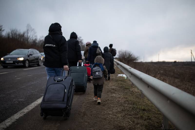 A family attempts to walk the last 25 kilometres of the journey to the Polish border.