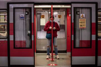 On the Milan metro, face masks and social distancing. AP