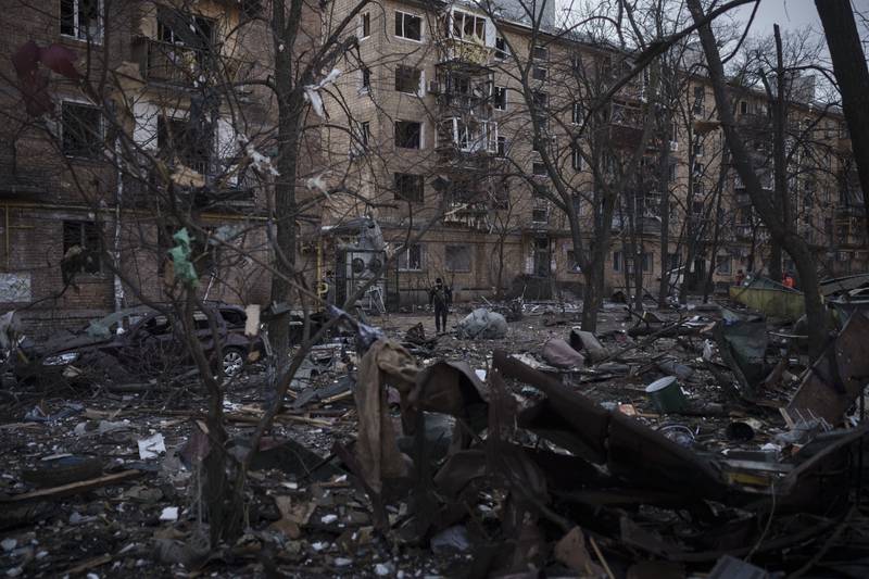 A police officer at abandoned residential buildings in Kyiv. AP