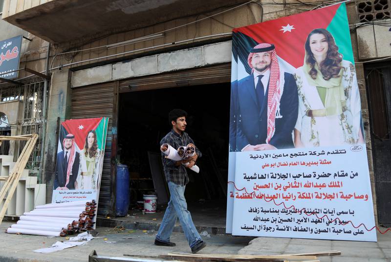 Posters depicting Prince Hussein and bride-to-be Ms Al Saif. Reuters