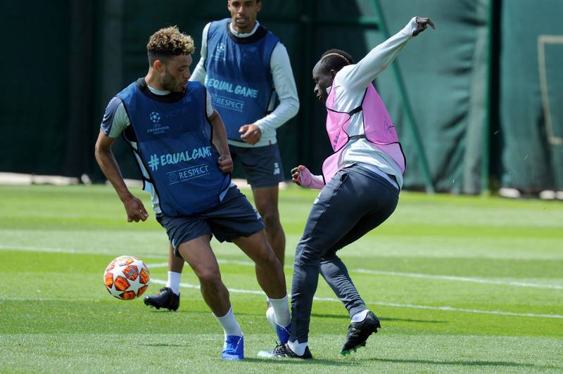 Liverpool's Alex Oxlade-Chamberlain, left, and Liverpool's Sadio Mane take part in training. AP Photo