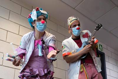 Two clowns of the Sunrise Media NGO (Medical Smile) perform at the Son Llatzer Hospital in Palma de Mallorca, Spain. AFP