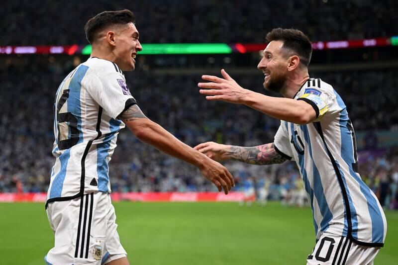 Nahuel Molina celebrates with Lionel Messi after scoring for Argentina. Getty