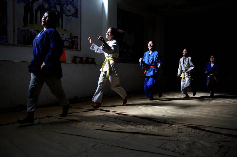 Members of Jiu Jitsu club run during a training session in Kabul. AP