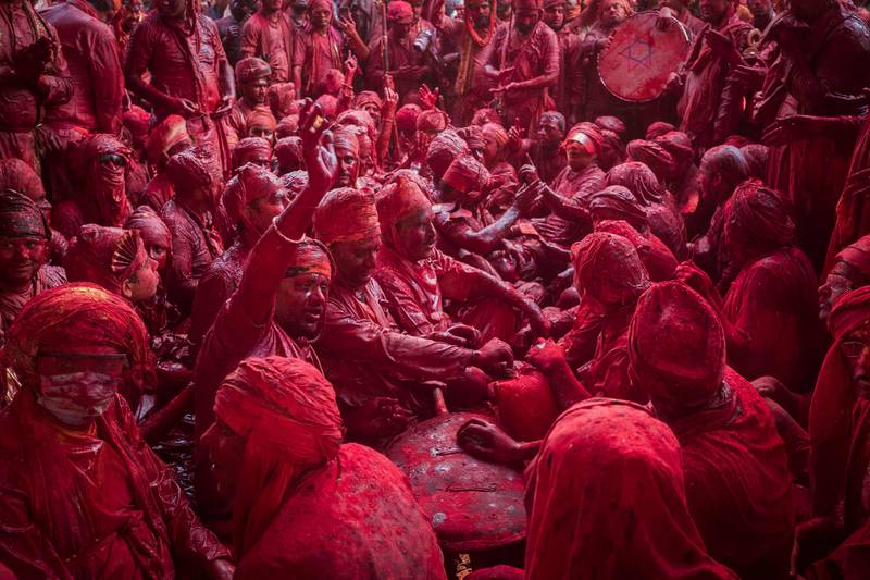 Revellers daubed in colours sing religious hymns at the Radha Rani temple during the Lathmar Holi celebrations in India’s Uttar Pradesh state. AFP