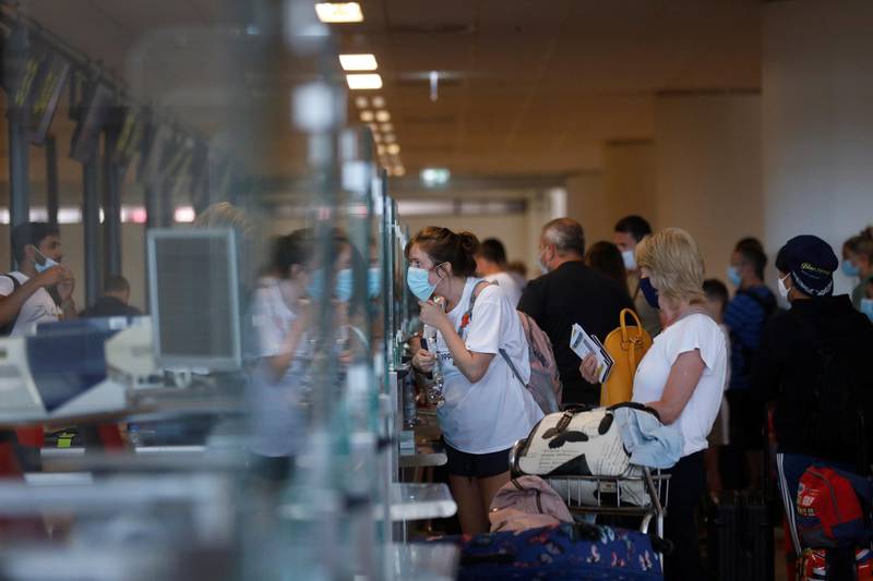 People queue at check in desks at Faro airport in Portugal. Reuters