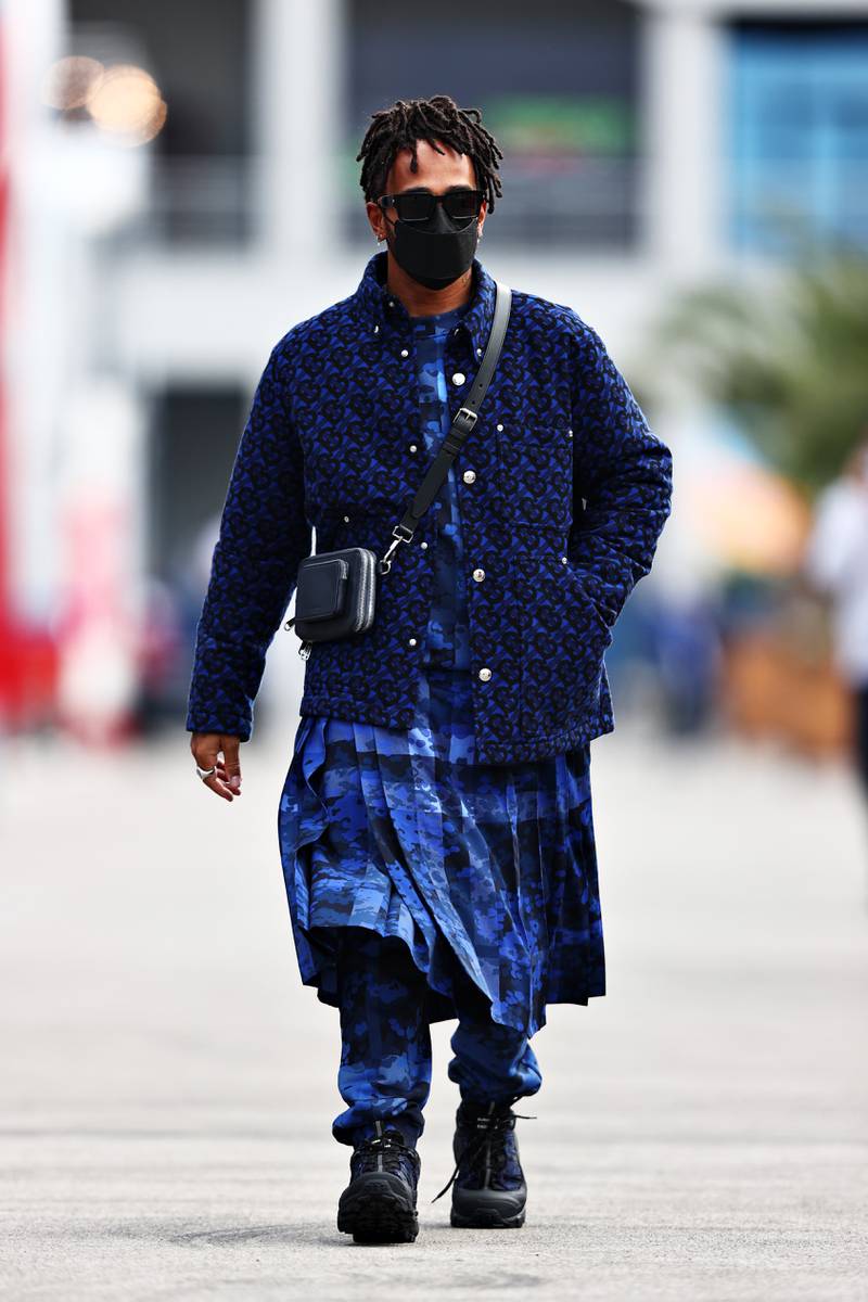 Lewis Hamilton, in a blue jacket over a kilt by Burberry, walks in the paddock during previews ahead of the Turkish Grand Prix at Intercity Istanbul Park on October 07, 2021. Getty Images