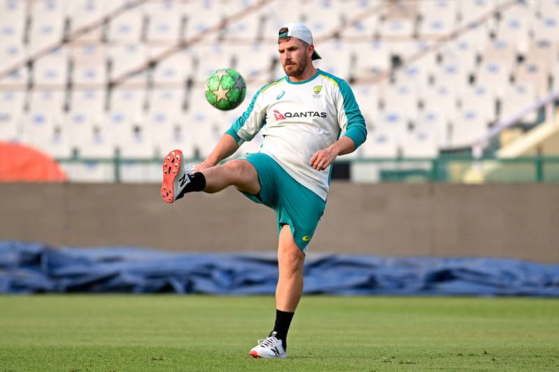Australia's captain Aaron Finch plays with a football in Mohali. AFP