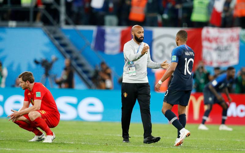 Belgium assistant coach, and former France striker, Thierry Henry congratulates France's Kylian Mbappe on his side's triumph. AP Photo