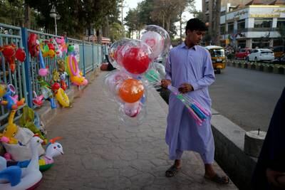 A balloon seller continues to work in Herat city centre, despite fighting taking place just a few kilometres away.