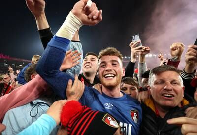 AFC Bournemouth's Mark Travers celebrates promotion to the English Premier League with fans on the pitch after the match against Nottingham Forest at the Vitality Stadium. Reuters