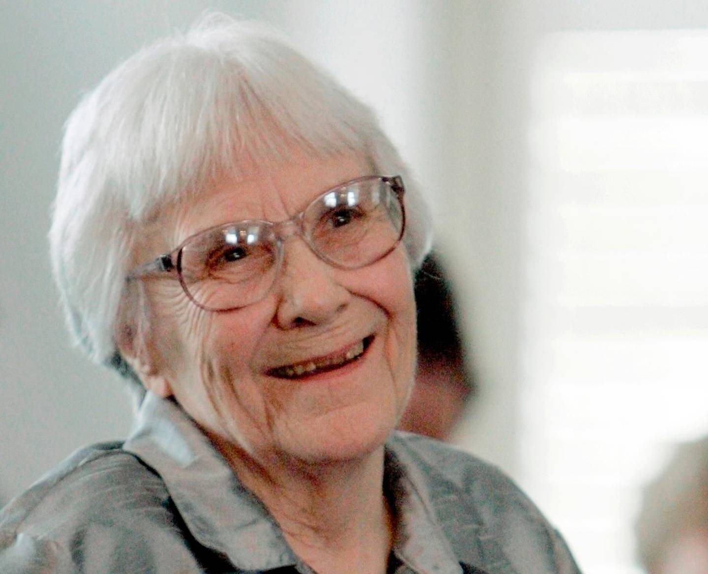 FILE - In this Aug. 20, 2007, file photo, author Harper Lee smiles during a ceremony honoring the four new members of the Alabama Academy of Honor at the Capitol in Montgomery, Ala. Six letters donated to Emory University and being made public Monday, April 2, 2018, show the author lamenting the conservative values of her native Monroeville, Alabama, and longing to back in New York. They also reflect her deep compassion for her father, A.C. Lee, the basis for the famous fictional lawyer Atticus Finch. (AP Photo/Rob Carr, File)