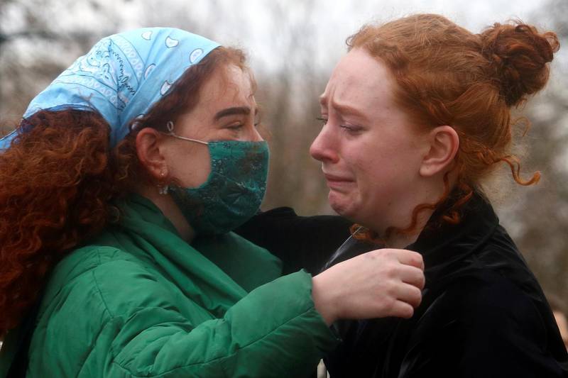 Women paying their respects to Sarah Everard console each other at a memorial site at Clapham Common, London. Reuters