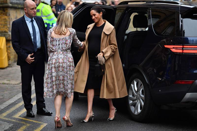 Meghan, Duchess of Sussex wears an Oscar de la Renta coat, Hatch dress and Gianvito Rossi heels visit the Smart Works charity in Londo on January 10, 2019. / AFP / Ben STANSALL