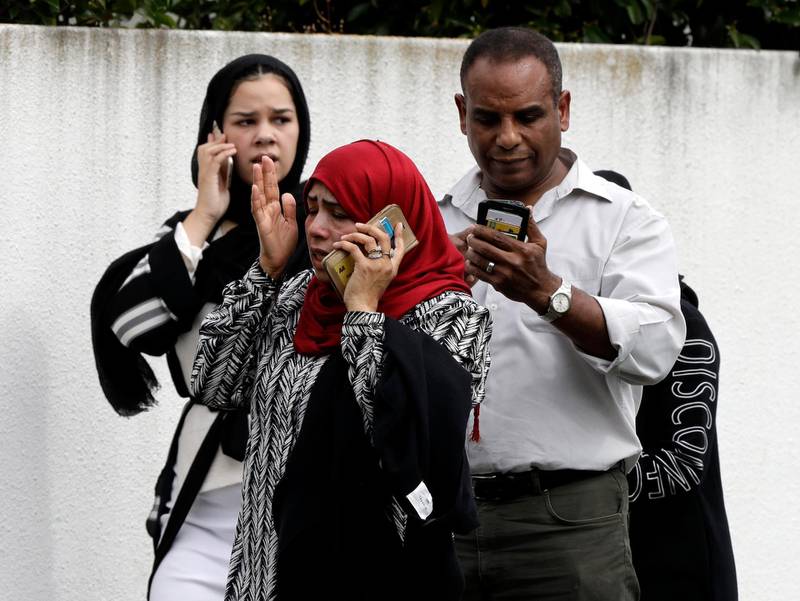 People call loved ones and relatives outside the mosque. AP Photo
