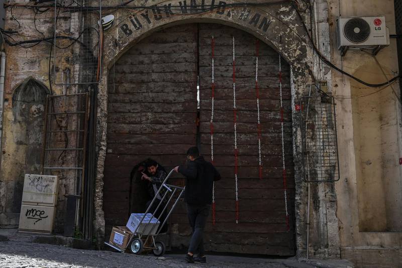 Two men talk in front of the Buyuk Valide Han, a historical caravanserai in Istanbul. AFP