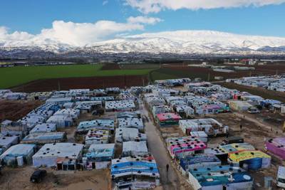 An aerial view shows an informal tent settlement housing Syrian refugees in the area of Delhamiyeh, in the central Bekaa Valley. Lebanon plays host to over one million Syrian refugees who fled as neighbouring Syrian fell into civil war at the start of March 2011.  AFP