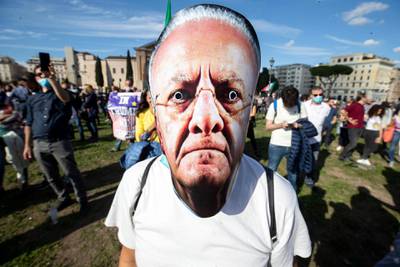 People attend a 'No Mask' protest rally 'Marcia della Liberazione' in Rome, Italy. The sit-in protest action is held against mandatory usage of face masks in public and in general against the government's management of the coronavirus Covid19 pandemic.  EPA