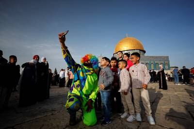 A clown takes a selfie with boys during celebrations with Palestinians in Jerusalem's Old City. Reuters
