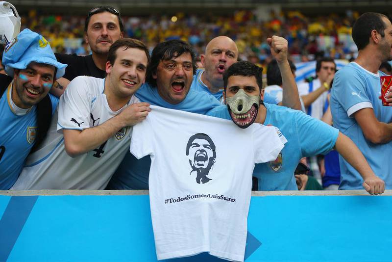 Uruguay fans holds up a t-shirt of Luis Suarez ahead of their team's match against Colombia on Saturday at the 2014 World Cup. Jamie Squire / Getty Images