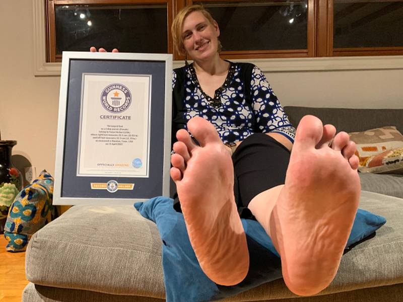 Tanya Herbert holds her Guinness World Record for largest feet. Photo: Guinness World Records