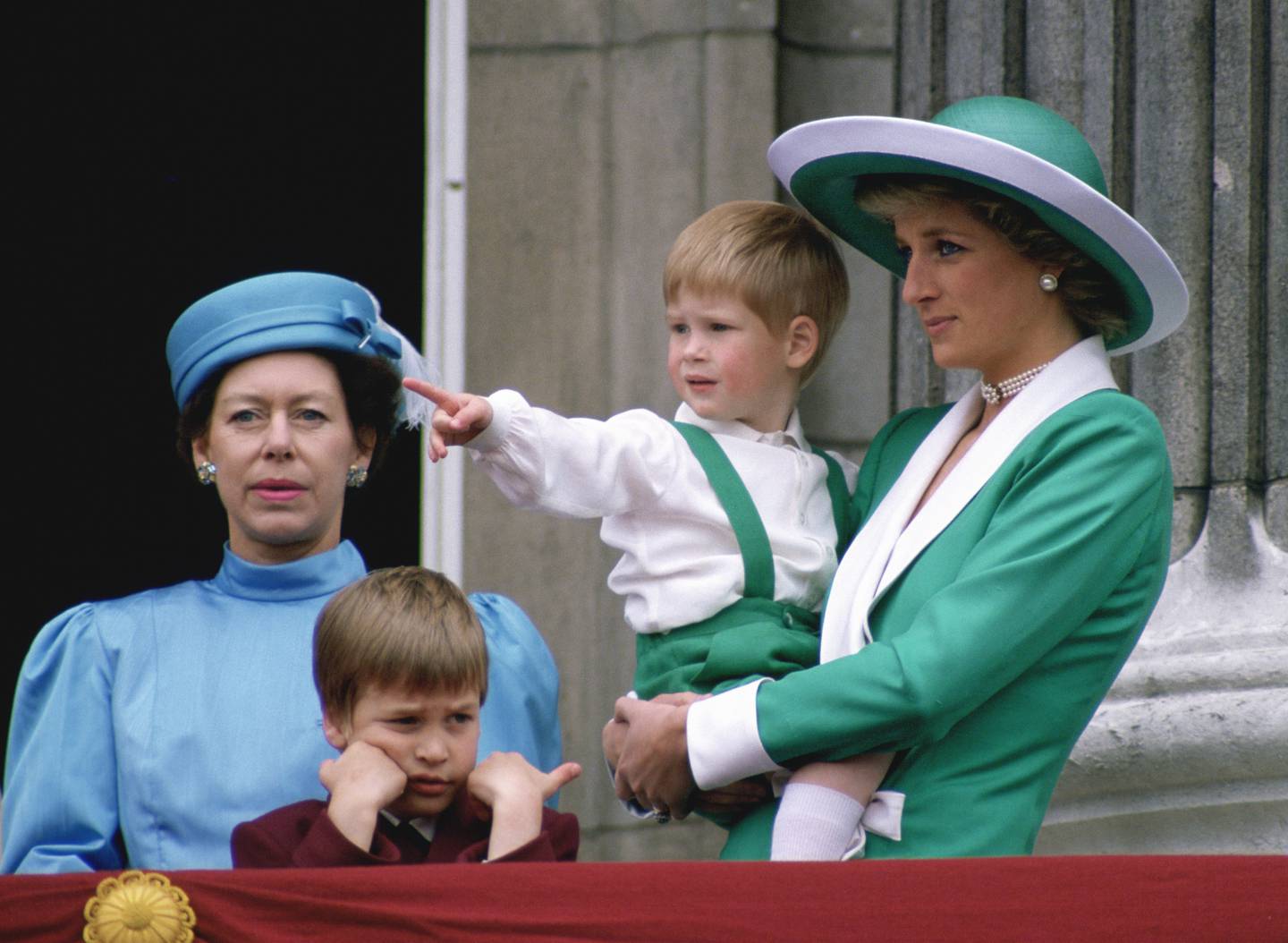 Princess Diana holding a young Prince Harry next to Princess Margaret on the balcony of Buckingham Palace. Getty Images