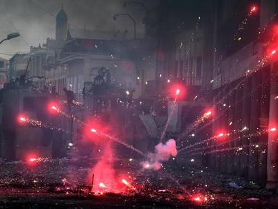 Iraqi protesters throw fireworks during clashes with anti-riot police forces at the Al Rasheed street in central Baghdad.  EPA