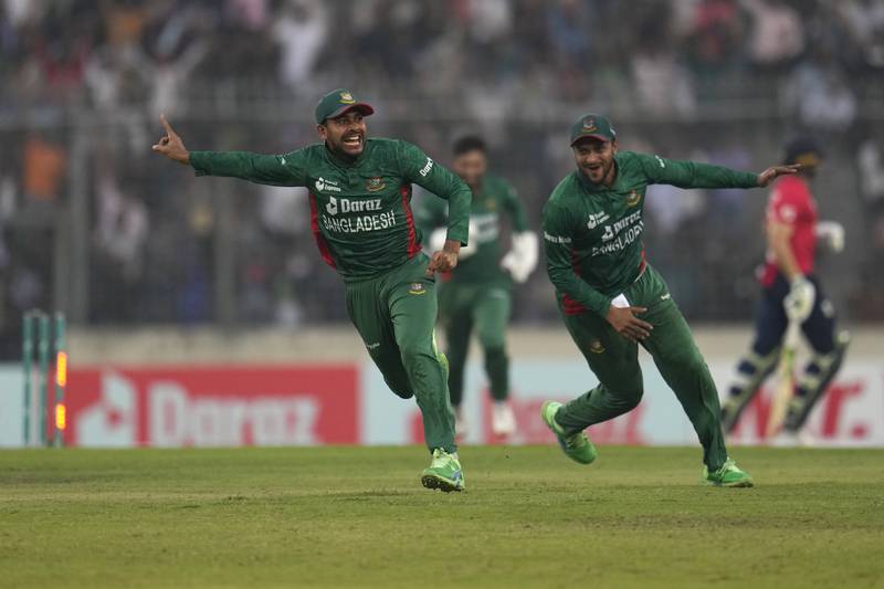 Bangladesh's Mehidy Hasan Miraz, left, celebrates running out England captain Jos Buttler. AP