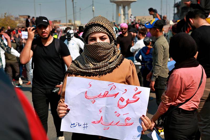An anti-government protester holds a placard with Arabic that reads, "We are a stubborn people," during ongoing anti-government protests, in Baghdad, Iraq, Sunday, February 23, 2020. AP Photo