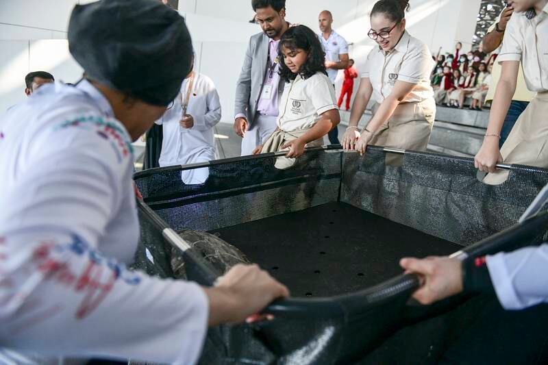 School children attended the ceremony to take part in the turtles' release
