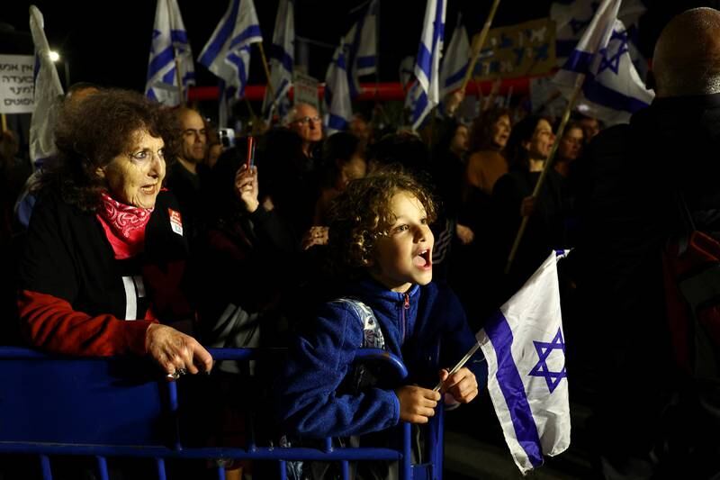 Demonstrators hold Israeli flags during a march in Jerusalem. Reuters