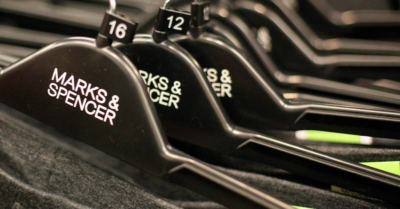 (FILES) In this file photo taken on January 06, 2009 Clothes hangers are pictured in a Marks and Spencers retail store in Loughton, east of London. British supermarket chain Marks & Spencer pledged on January 6, 2021, not to use cotton from China's Xinjiang region in clothing it sells, a move to call for "change" in Beijing's treatment of the Uyghur minority. / AFP / SHAUN CURRY
