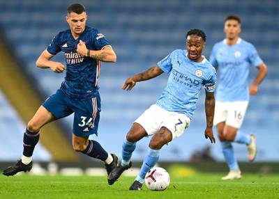 City attacker Raheem Sterling holds off the attentions of Granit Xhaka. EPA