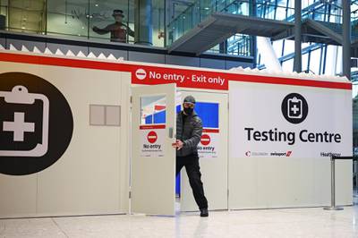 A man opens the door of a testing cente at Heathrow Airport. Reuters
