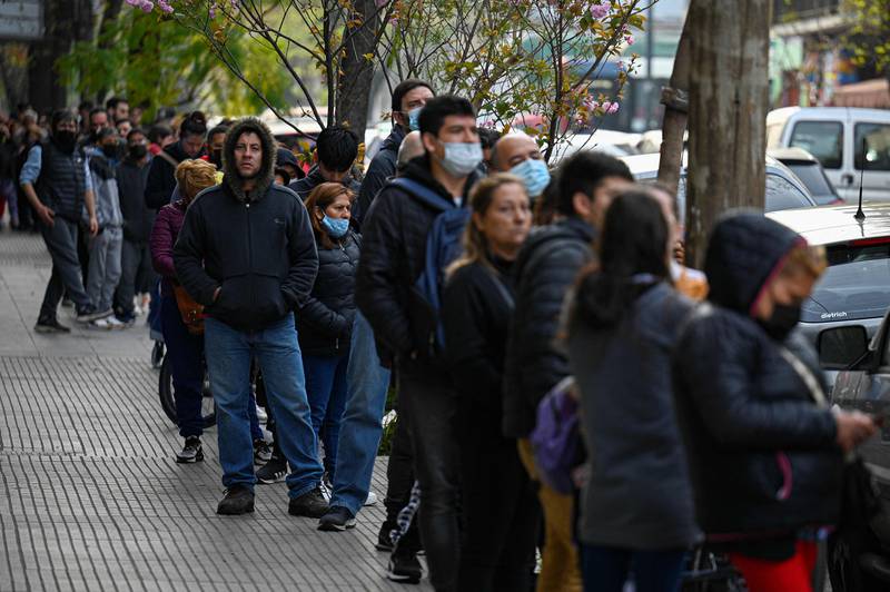 People line up to buy Panini World Cup football stickers in a street in Buenos Aires. AFP