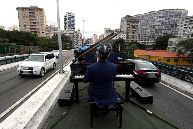 Pianist Rodrigo Cunha serenades from an open truck the lonely mothers in quarantine as the spread of the coronavirus disease (COVID-19) continues in Sao Paulo, Brazil. REUTERS