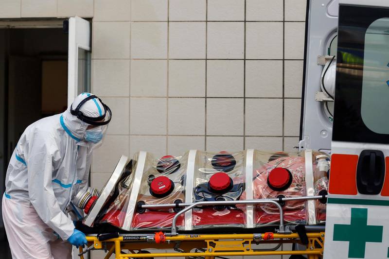 A patient on a biocontainment stretcher is taken out of an ambulance to be transferred to the San Filippo Neri hospital in Rome, Italy. AP Photo