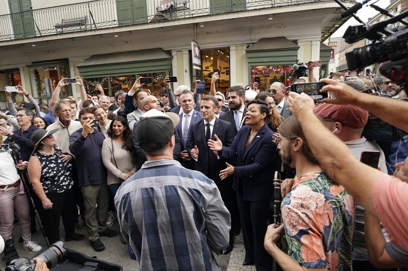 Mr Macron claps during a street band's performance on Royal St in the French Quarter of New Orleans alongside Mayor Latoya Cantrell. AP