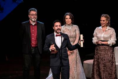 Tunisian director Mehdi Barsaoui receives the award for Best Arabic Film for 'A Son' during the closing ceremony of the 41st Cairo International Film Festival. AFP