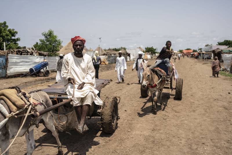 An Eritrean man rides his donkey-drawn cart to the market at the camp. Getty