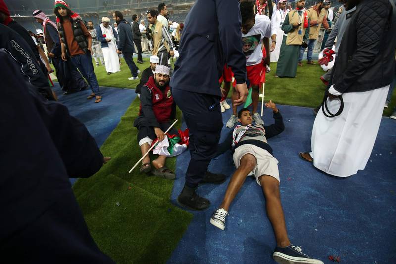Wounded fans await treatment after a glass barrier broke at the end of the Gulf Cup of Nations 2017 final football match between Oman and the UAE at the Sheikh Jaber al-Ahmad Stadium in Kuwait City on January 5, 2018. Yasser Al-Zayyat / AFP