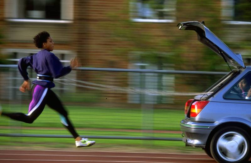 British athlete Marcia Richardson chases after a Ford Fiesta during a training run in Windsor, in 1993. Getty Images