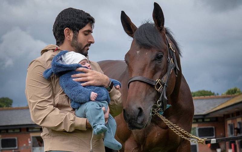 Sheikh Hamdan with his baby boy, Sheikh Rashid bin Hamdan, at the Godolphin Stables in England. Photo: Instagram / Faz3