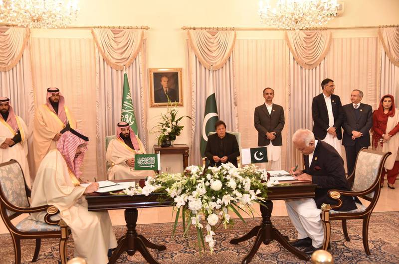 Imran Khan and Mohammad Bin Salman look on as the officials sign deals in Islamabad. EPA