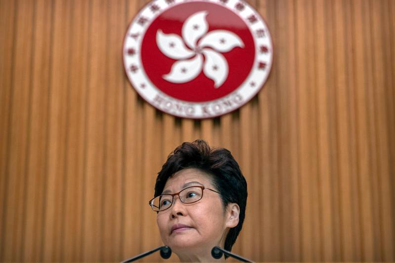 Hong Kong Chief Executive Carrie Lam listens to a journalist's question during a press conference at the government building in Hong Kong, Tuesday, Oct. 15, 2019. A homemade, remote-controlled bomb intended to "kill or to harm" riot control officers was detonated as they deployed against renewed violence in Hong Kong over the weekend, police said Monday, in a further escalation of destructive street battles gripping the business hub. (AP Photo/Mark Schiefelbein)