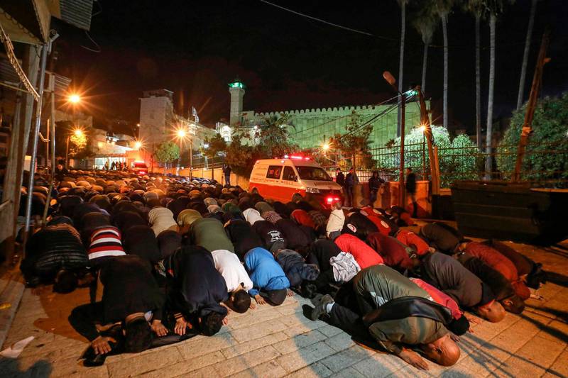 Palestinian Muslim worshippers prostrate in prayer early in the morning outside the Ibrahimi mosque, also known as the Tomb of the Patriarch -- a site holy to both Muslims and Jews where biblical patriarch Abraham is believed to have been buried, in the flashpoint city of Hebron in the occupied West Bank.  AFP