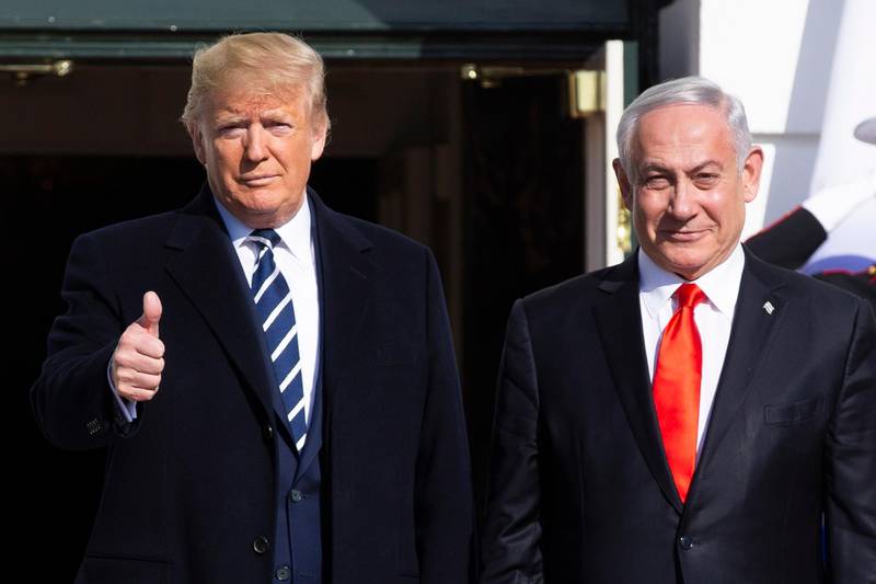 US President Donald Trump (left) gestures while greeting Prime Minister of Israel Benjamin Netanyahu (right) upon his arrival at the South Portico of the White House, in Washington.  EPA