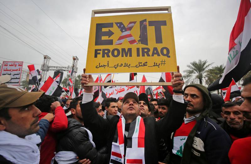 Protesters raise a placard as supporters of Moqtada Al Sadr gather in the capital Baghdad. AFP