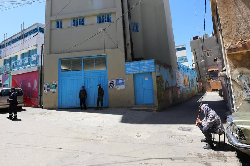 Security personnel stand outside an UNRWA school building, used as isolation centre for coronavirus patients, at the Wavel Palestinian refugee camp in Baalbek, in Lebanon's Bekaa valle. Reuters